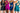 Four women wearing colorful athletic outfits on a plain background