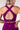 Purple sports bra with criss-cross back design on a plain background