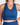 Person wearing a blue sports bra and leggings on a white background