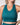 Teal sports bra worn by a person on a plain background