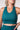 Teal sports bra worn by a person on a plain background