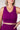 Person wearing a purple athletic outfit against a plain background