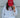 Person wearing a white sweatshirt and red cap with 'LINCOLN Ladies' text against a gray wall.