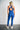 Person wearing a blue bra and leggings with a white background