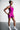 Person wearing a purple athletic outfit on a plain background