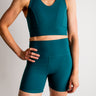 Person wearing a teal athletic outfit on a plain background