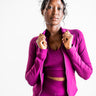 Woman wearing a bright pink athletic outfit on a white background