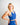 Woman wearing a blue athletic outfit against a plain background